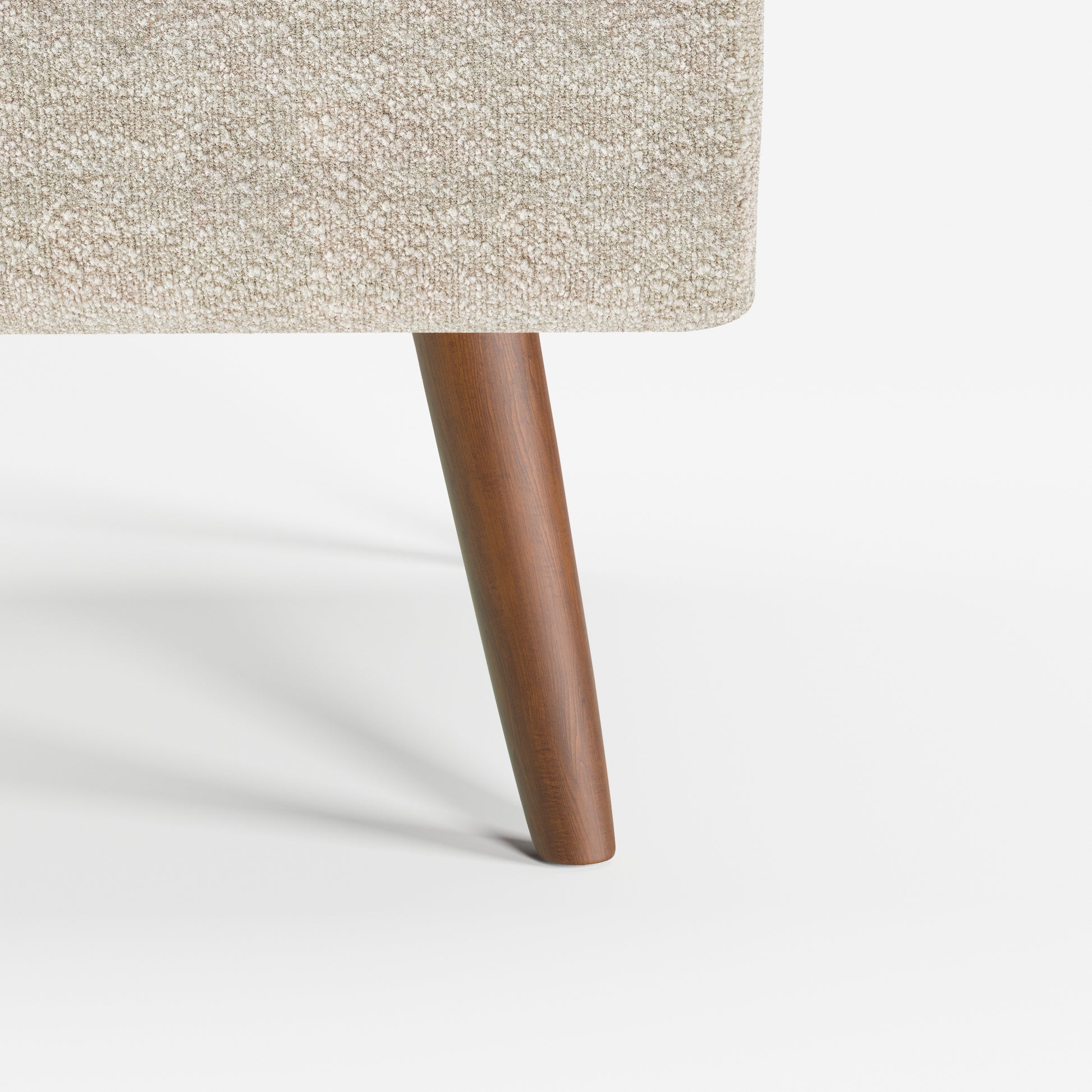 Arlo Accent Armchair in Ivory Tweed Color featuring a close-up of the tapered solid wood leg and textured ivory tweed upholstery detail.